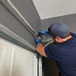 Man Repairing Garage Door Spring