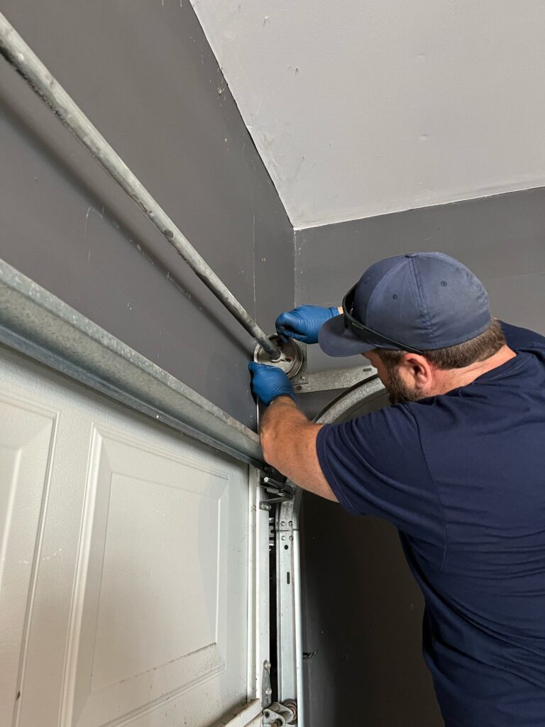 Man Repairing Garage Door Spring